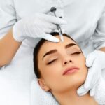 Skin specialist examining a patient for acne and skin conditions