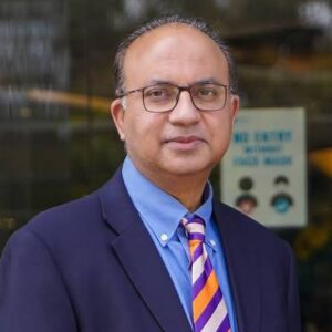 Prof. Dr. Azim Jahangir Khan examining a patient during a dermatology consultation for eczema evaluation.