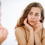 Skin care expert diagnosing skin problems